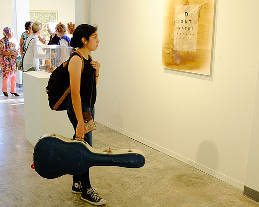 Student looking at artwork in a gallery